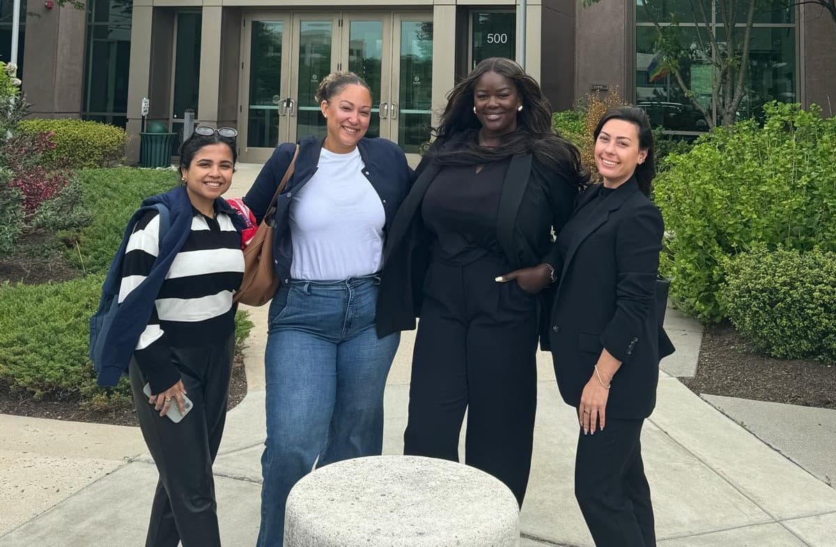 Joy Osinloye with colleagues outside a client office building